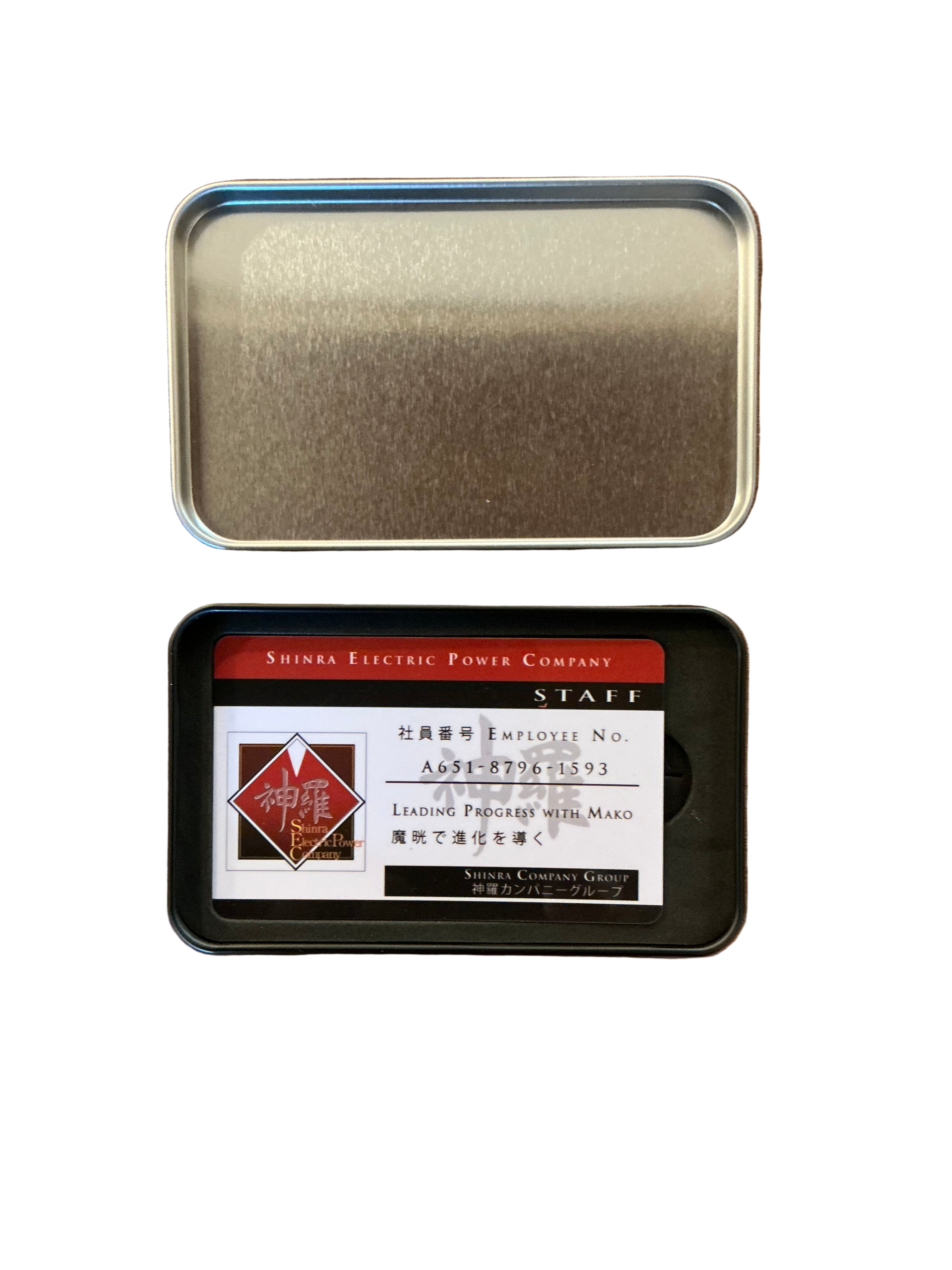 An open Final Fantasy 7 remake tin that shows a mockup of an ID card for the Shinra Company.