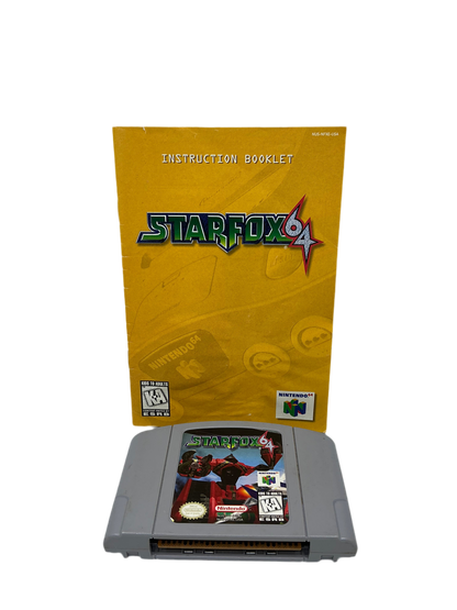 The inner game manual and cartridge for Star Fox 64.The manual has minor edgewear and the cartridge is clean.