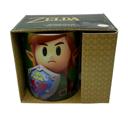 Mug with simplistic character art of Link from Link's Awakening in a 'The Legend of Zelda' box.
