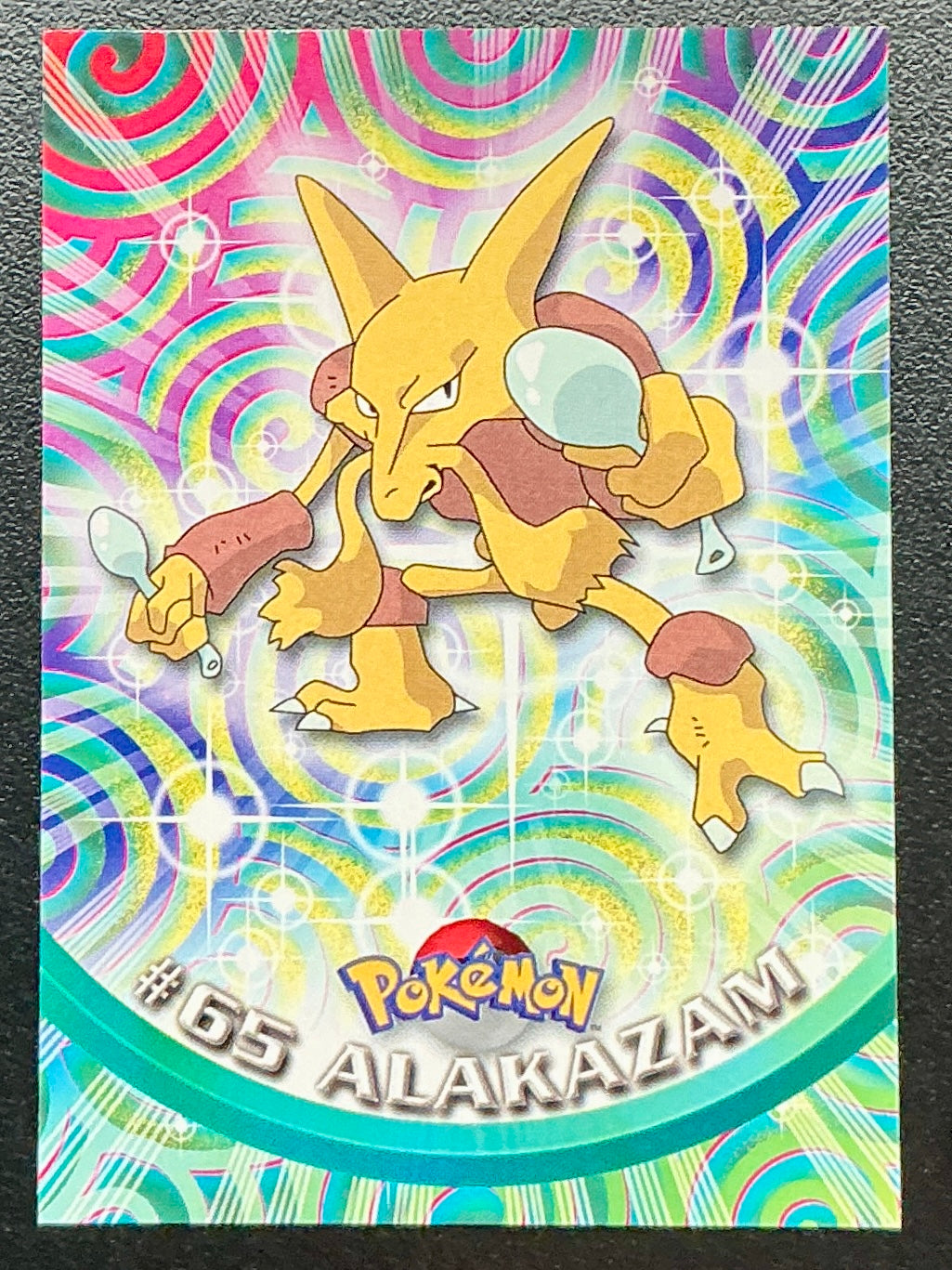 Pokémon Topps Alakazam #65 Series 1 (Black Logo)